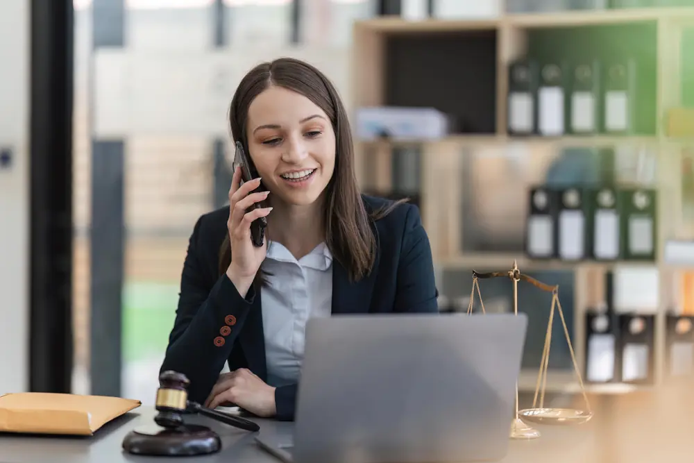 Lawyer on the phone at her desk in a law office